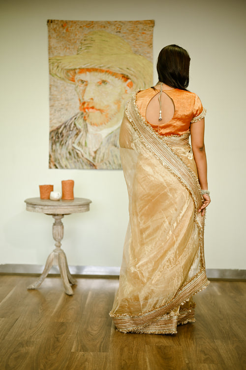 Beige gold silk tissue sari with heavy border