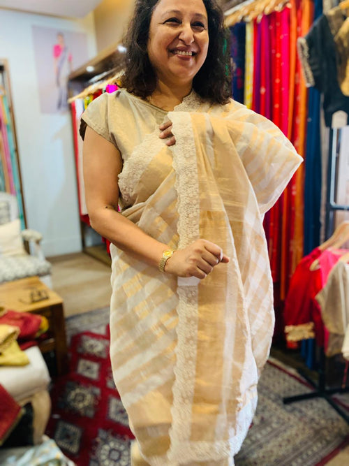 offwhite and golden hued handloom tissue silk saree