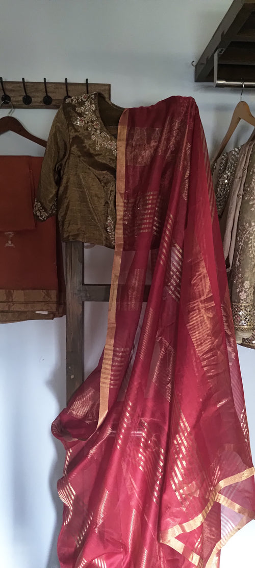 Red soft saree with golden lines